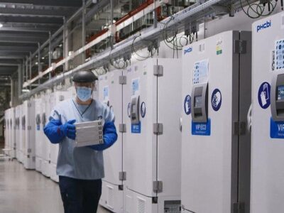 Man with mask holding pharmaceutical boxes